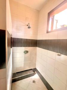 a bathroom with a shower with black and white tiles at A private room in,Coastal Bliss homestsy in Mombasa