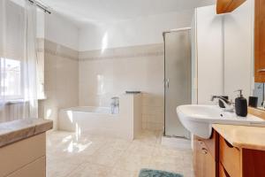 a bathroom with a tub and a sink and a shower at La dimora del Gallo in Concorezzo