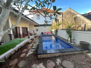 a swimming pool in the backyard of a house at Brian Homestay in Nusa Dua