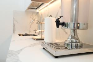 a kitchen counter with a food processor and a roll of paper towels at Hotel Colina Inn Escazu in San Rafael