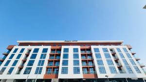 a tall apartment building with a blue sky in the background at Sunday Sheikh Zayed Road Concord Tower by Belvilla in Dubai