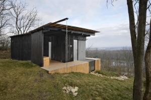 a small house on top of a hill at Veritas Beyond Glamping in Hošťka