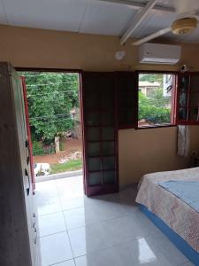 a room with a bed and an open door at Habitación para 2 personas in Villa Elisa