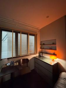 a room with a desk with a lamp and a chair at Studio 3 ByhomeLinh Phố Cổ Hoàn Kiếm in Hanoi