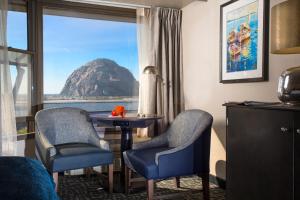 a room with a table and two chairs and a window at Blue Sail Inn in Morro Bay