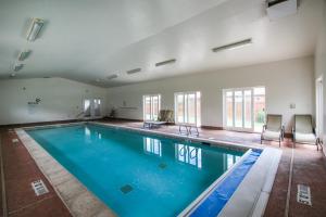 a large swimming pool in a building with chairs at Cottonwoods 455 in Moab
