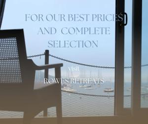 a bench in front of a window with a view of the ocean at Peaceful & Tranquil Cottage With Private Terrace at 'The Pink House' in Falmouth