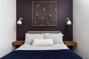 a bedroom with a bed and a picture on the wall at Peaceful & Tranquil Cottage With Private Terrace at 'The Pink House' in Falmouth