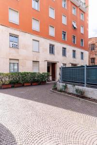 an empty street in front of a building at Youhosty - Brera 17 in Milan