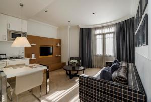 a living room with a couch and a dining room at Atik Suite Taksim in Istanbul