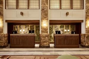 a lobby with two reception desks in a building at The Palace, a Luxury Collection Hotel, Madrid in Madrid