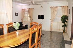 a living room with a table and a couch at Stunning 2 Bedroom Affordable pl in Kumasi