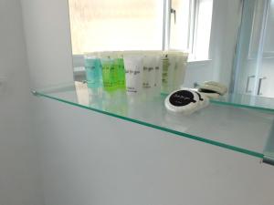 a glass counter top with some products on it at No 3 - Modern Studio Apartment in Lanark Town Centre in Lanark