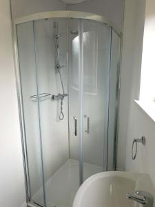 a glass shower in a bathroom with a toilet at No 3 - Modern Studio Apartment in Lanark Town Centre in Lanark