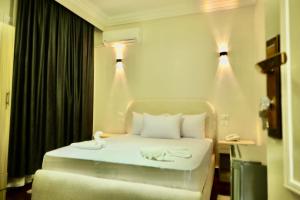 Een bed of bedden in een kamer bij Triple garden view hotel