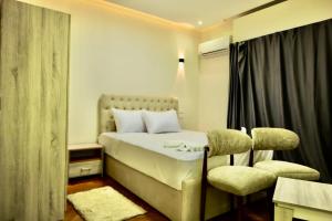 Een bed of bedden in een kamer bij Triple garden view hotel