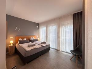 Кровать или кровати в номере Ferienwohnung Backbord im Quartier Sellin