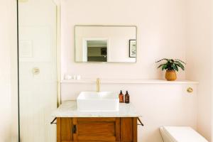 a bathroom with a sink and a mirror at Cotteswold House in Bibury +43 photos