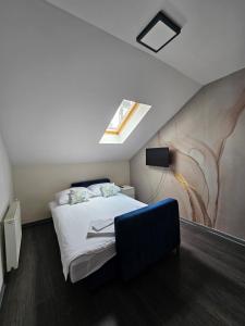 a bedroom with a bed and a painting on the wall at KAPTOL Rooms in Zagreb