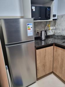 Kuchyň nebo kuchyňský kout v ubytování Acogedor y moderno apartamento, zona tranquila, vista espectacular + 7 fotografií