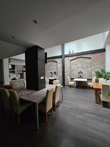 a dining room with a table and chairs and a fireplace at KAPTOL Rooms in Zagreb