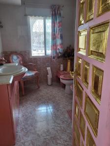 a bathroom with a sink and a toilet and a door at SolyMar Mediterraneo in Oropesa del Mar