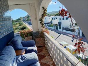 a balcony with blue couches and a view of a city at SolyMar Mediterraneo in Oropesa del Mar