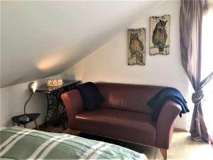 a living room with a couch and a bed at Ferienwohnung Eulennestle in Lenzkirch