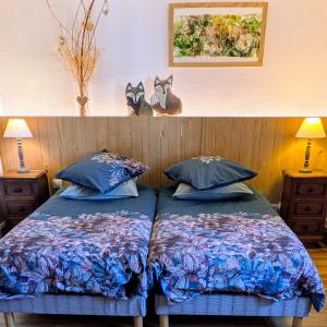 a bedroom with two beds and two stuffed animals on the wall at La Renardière in Reichshoffen
