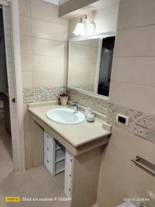 a bathroom with a sink and a mirror at La Chicca nel Centro in Massafra