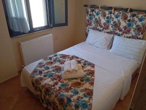 a bedroom with a bed with towels on it at Nea Peramos in Nea Peramos