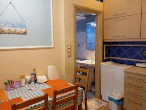 a kitchen with a table and a kitchen with a sink at Nea Peramos in Nea Peramos