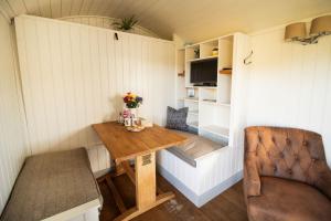 a tiny house with a table and a chair at Sunflower in Saint Harmon +16 photos