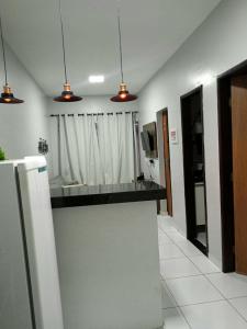 a kitchen with a counter top in a room at DUNAS RESIDENCE CASA 02 in Santo Amaro