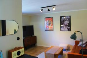 a living room with a couch and a mirror at Leśne Szlaki AP Apartment's in Jedlina-Zdrój