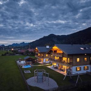 an aerial view of a house with a playground at activechalets six.nine.eight in Reit im Winkl