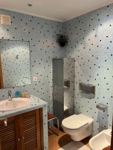 a bathroom with a toilet and a sink at Seazimbra - Luxury Apartment in Sesimbra +34 photos