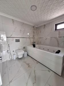 a white bathroom with a tub and a toilet at Daly Resort 2 in Sapanca +10 photos