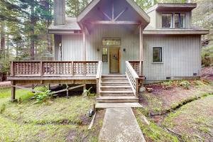 a home with a porch and stairs to the front door at Enchanted Meadows in Gualala