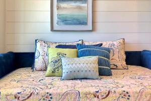a bed with pillows on top of it at Hillside Farm’s Cottages in Paris
