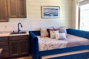 a blue couch in a kitchen with a sink at Hillside Farm’s Cottages in Paris