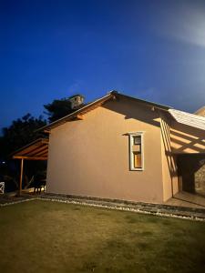 a house with a window on the side of it at Shaheen Bagh - A Luxury Boutique Resort & Spa in Rājpur