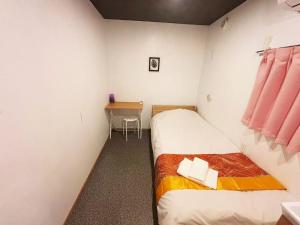 two beds in a room with a desk and a table at Hananogo Ikebukuro - Vacation STAY 16071v in Tokyo