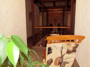 a wooden chair in a room with a table at Suites BELLAHELLIN in Hellín