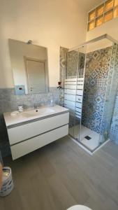 a bathroom with a sink and a shower at Quiet House - appartamento Maestrale in Porto Torres