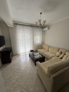 a living room with a couch and a table at Lia Apartments 1 in Kallithea Halkidikis