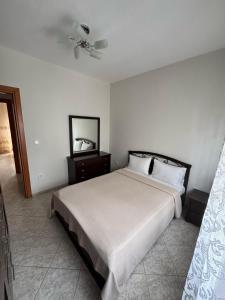 a bedroom with a bed and a ceiling fan at Lia Apartments 1 in Kallithea Halkidikis +2 photos