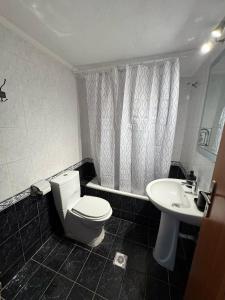 a bathroom with a toilet and a sink at Lia Apartments 1 in Kallithea Halkidikis