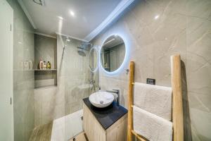 a bathroom with a sink and a mirror at Windmill Escape Apartments A in Chios
