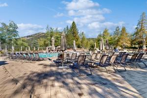 a group of chairs and umbrellas next to a pool at Everline #350 in Olympic Valley